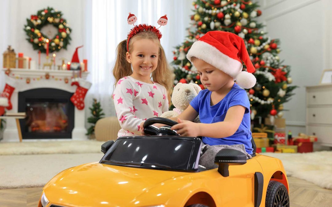 2 kids happy over new christmas model car