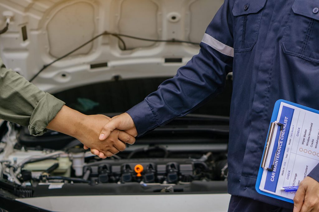 mechanic shaking hands with customer