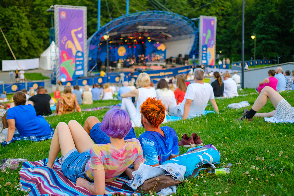 Audience sitting on plaids in park