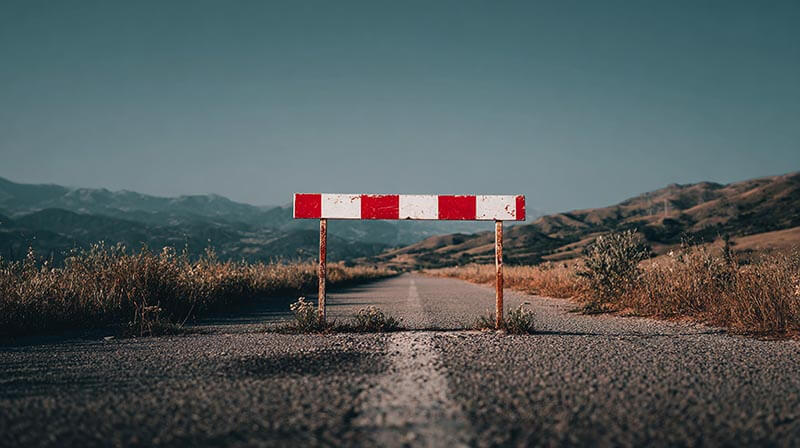 barrier on the road a stark red and white