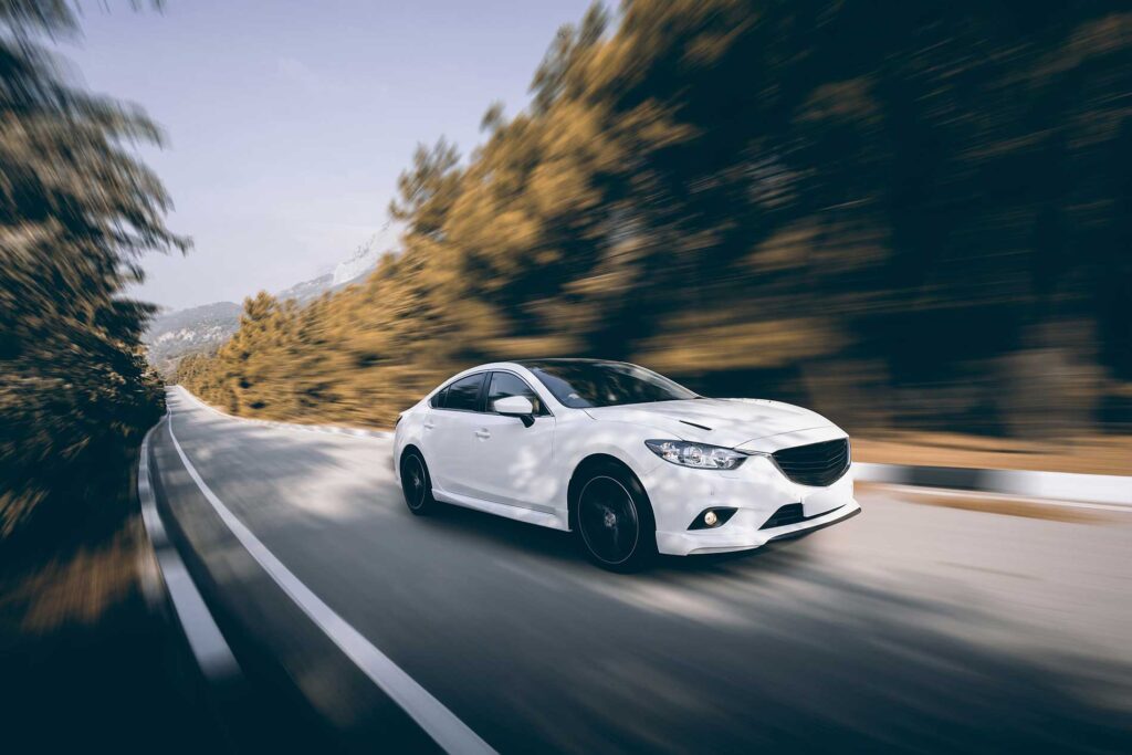 car speeding along a highway car speeding along a highway