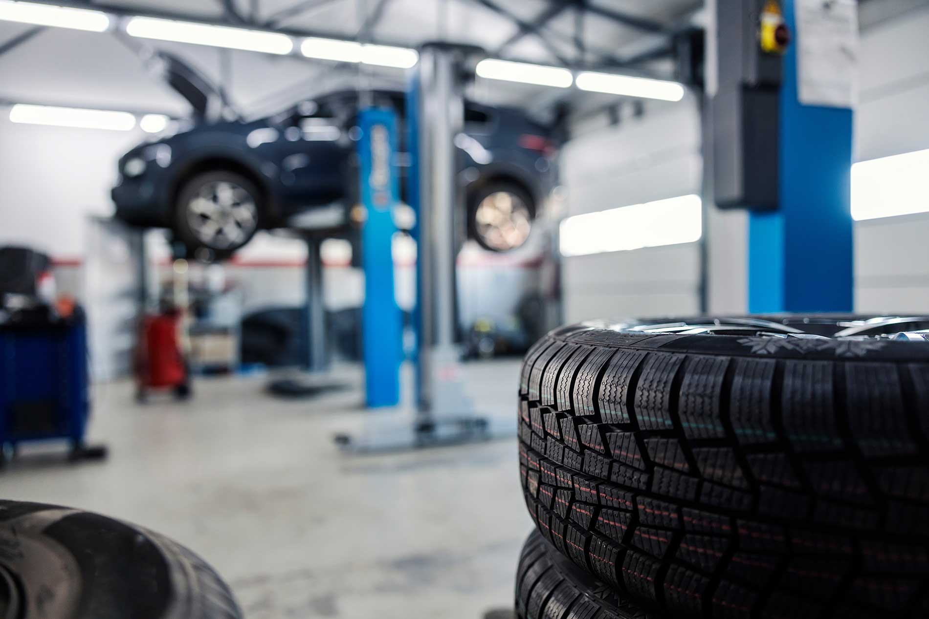 vehicles-hoisted-up-and-worked-on-by-technicians vehicles-hoisted-up-and-worked-on-by-technicians